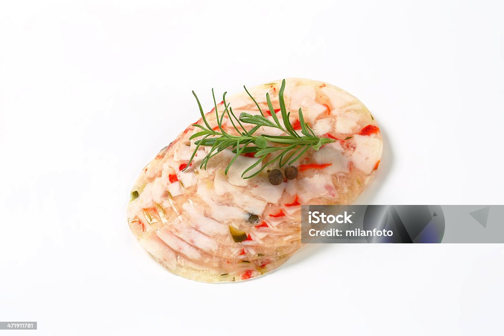 chicken meat and vegetables in aspic slices of chicken meat and vegetables in aspic with peppercorns and rosemary on white background Appetizer Stock Photo