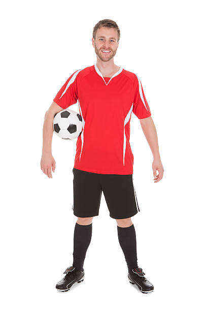 istock Soccer Player Holding Football 471912156