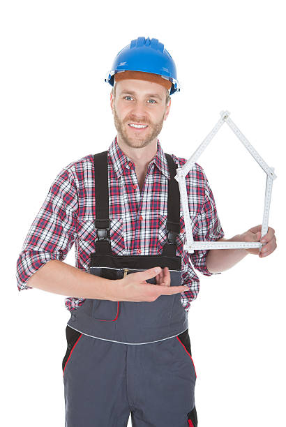 istock Male Architect Holding House Frame 471912186