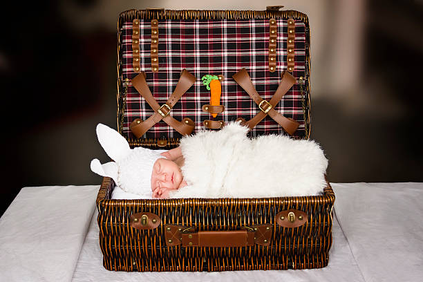 sleeping baby in a suit of abbit stock photo