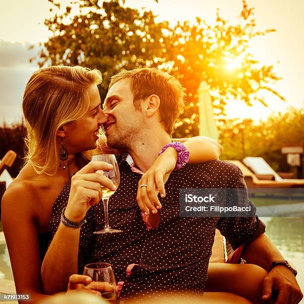 Young Couple Having Aperitif Near The Swimming Pool Stock Photo - Download Image Now