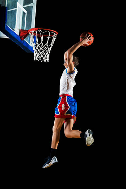 istock Basketball player slam dunking the ball. 471913541