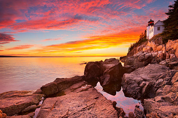 Bass Harbor Head Lighthouse, Acadia NP, Maine, USA at sunset The Bass Harbor Head Lighthouse in Acadia National Park, Maine, USA. Photographed during a spectacular sunset. lighthouse maine new england coastline stock pictures, royalty-free photos & images