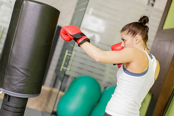istock Young woman boxing 471914753
