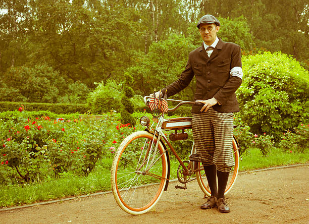 Member of the Historic Bike Ride posing with retro bicycle in the park Sokolniki. At this event participants in period costumes ride vintage and military bikes from 19-20th centuries
