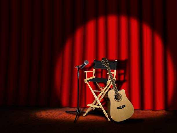 istock Microphone and Guitar on stage with Curtains 471916349