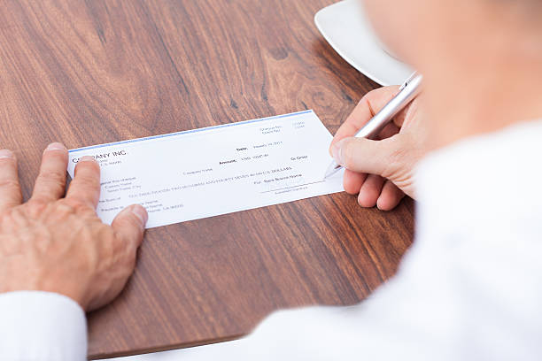 istock Person Filling Cheque 471916404