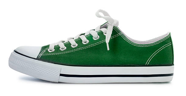 Green Sneaker on a White Background This is a photo of classic green sneaker isolated on a white background. canvas shoe photos stock pictures, royalty-free photos & images