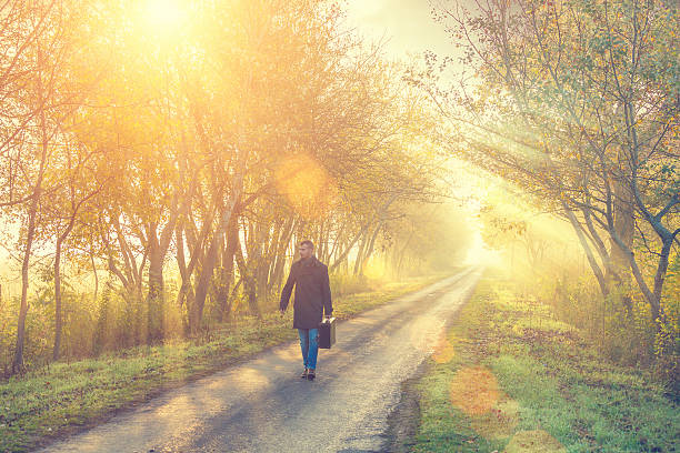 istock young man on the road with a suitcase 471917391