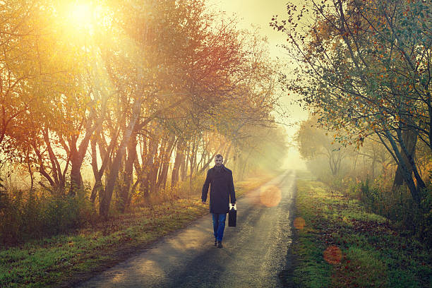 istock young man on the road with a suitcase 471917393