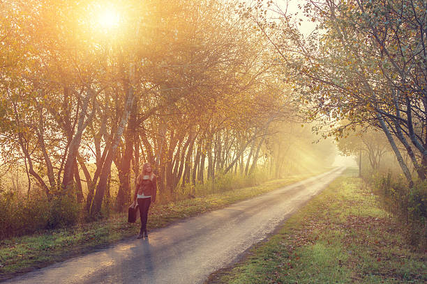 istock young woman on the road with suitcase 471917401