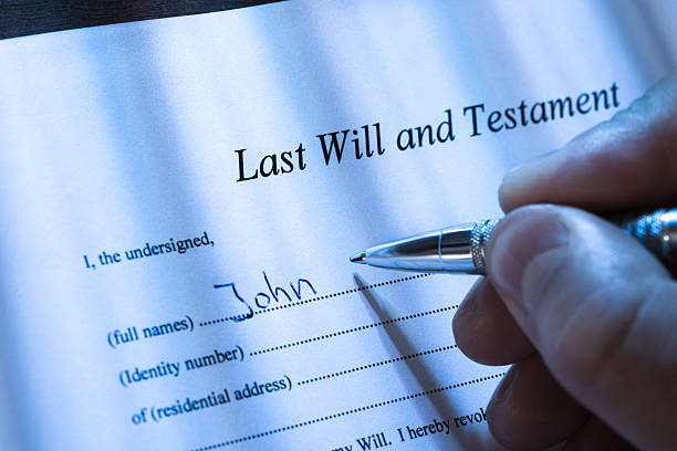 istock Person Writing Last Will and Testament 471917782