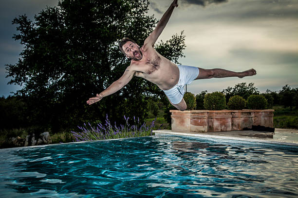 Man Diving into Swimming Pool