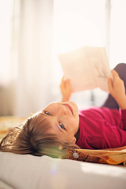 istock Beautiful little girl reading 471919125