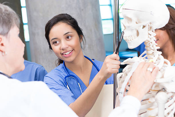 istock Young nursing or medical student asking question during anatomy class 471919711