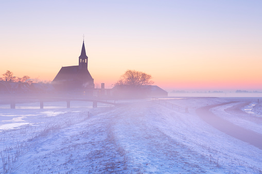 A frozen winter landscape in The Netherlands, photographed at sunrise.