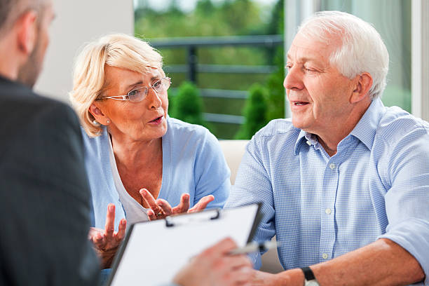 istock Senior couple talking with financial advisor 471920115