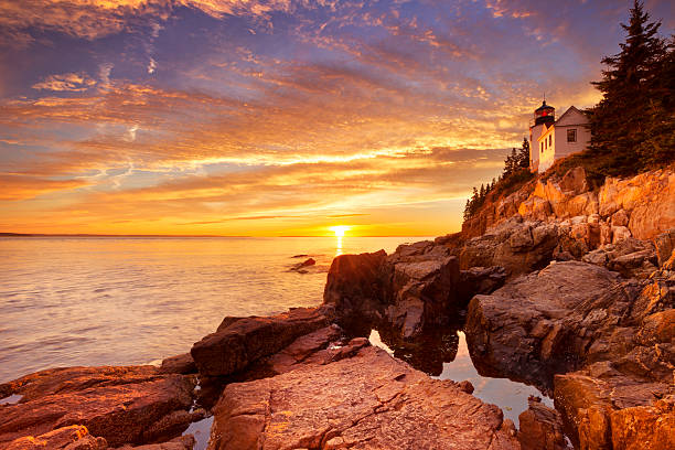 Bass Harbor Head Lighthouse, Acadia NP, Maine, USA at sunset The Bass Harbor Head Lighthouse in Acadia National Park, Maine, USA. Photographed during a spectacular sunset. saturated color stock pictures, royalty-free photos & images