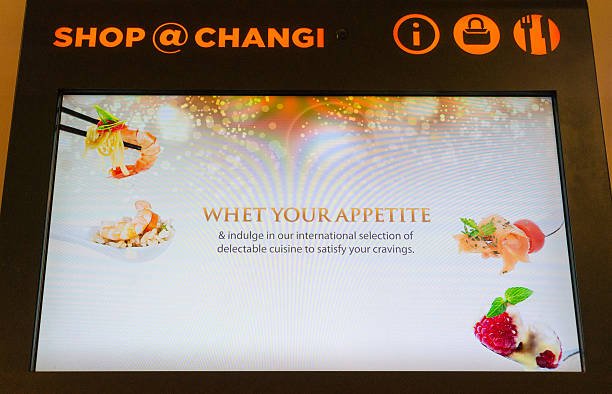 Glorious shopping area in Changi International Airport Singapore, Singapore - January 25, 2015: Glorious duty free shopping area in Changi International Airport on January 25, 2015 in Singapore. Changi Airport serves more than 100 airlines operating 6,400 weekly flights connecting Singapore to over 300 cities worldwide. retail digital signage stock pictures, royalty-free photos & images
