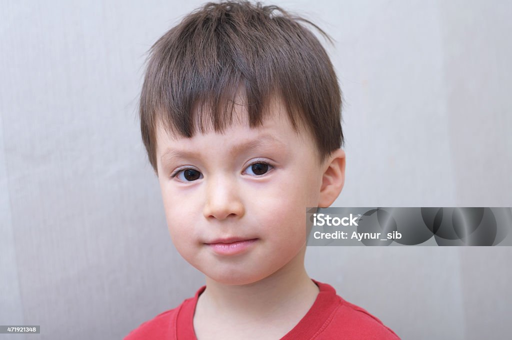 boy portrait Caucasian boy face portrait in red skirt 2015 Stock Photo