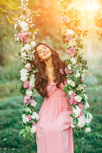 istock Beautiful young girl on a swing 471922278