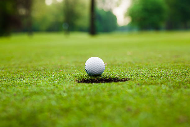 istock Golf ball on green meadow. 471922456