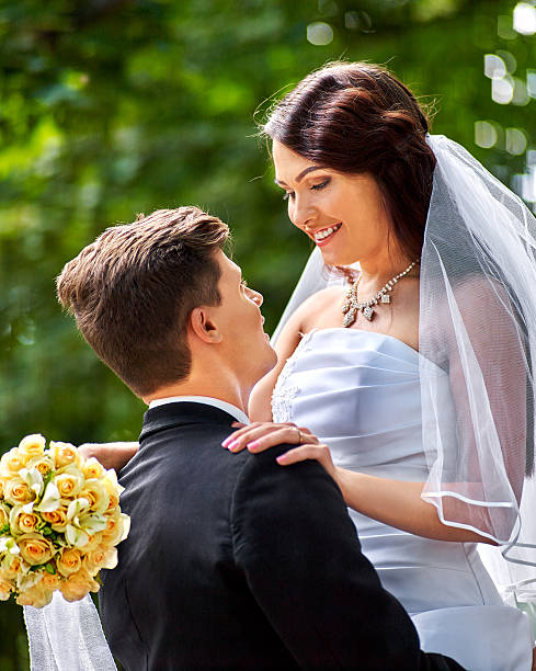 istock Bride and groom with flower outdoor 471923982