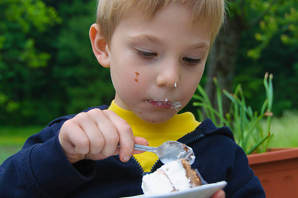 Boy eating cake stock photo