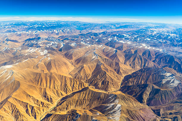 aerial view of mountains and clouds on top