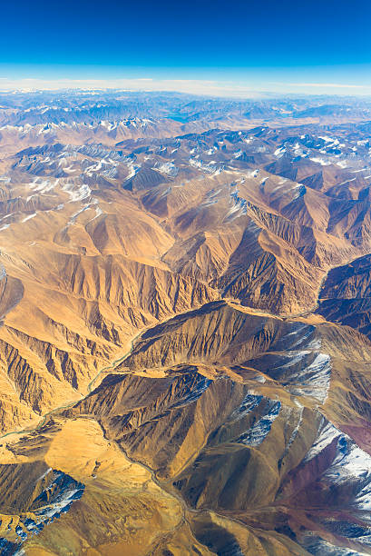 aerial view of mountains and clouds on top