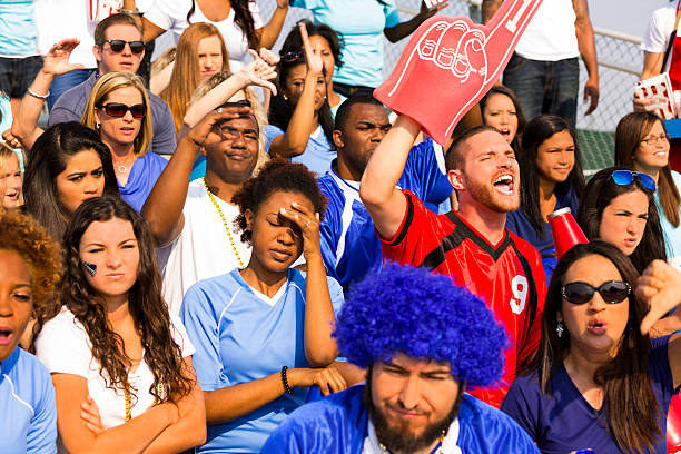 istock Sports: One fan cheers, others 'boo' for opposite team. 471924821