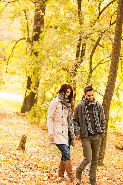istock Smiling couple walking in the park 471926669