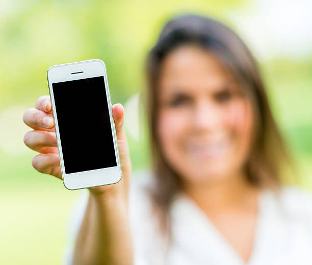 istock Woman holding smart phone 471927025
