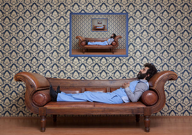 Mesmerized man lying down on coach in psychiatrist office.