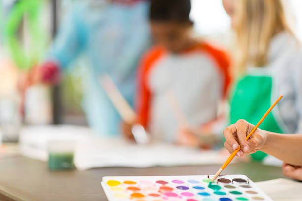 Elementary age children at the art center working on a creative project.