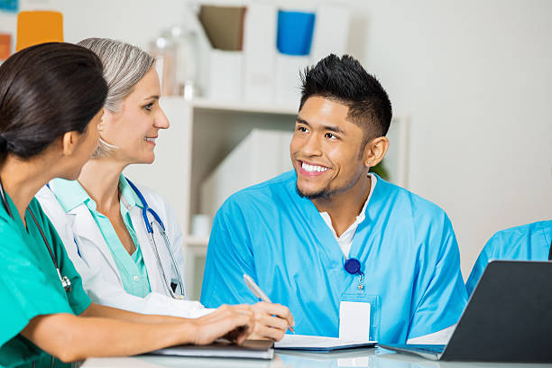 istock Asian nurse or doctor discussing policy changes during staff meeting 471928603