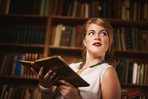 istock Beautiful young woman in library 471929641