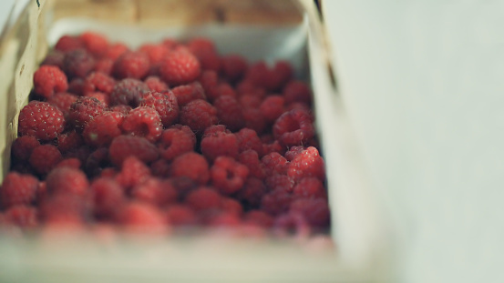 Fresh organic raspberry in basket. Selective focus with copy space