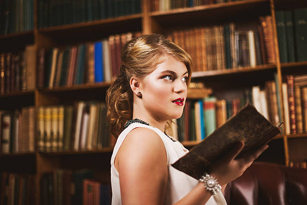 istock Beautiful young woman in library 471931595