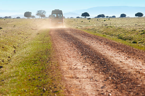 istock Dirty road in a mediterranean meadow with minibus. Cabeneros. Sp 471931636