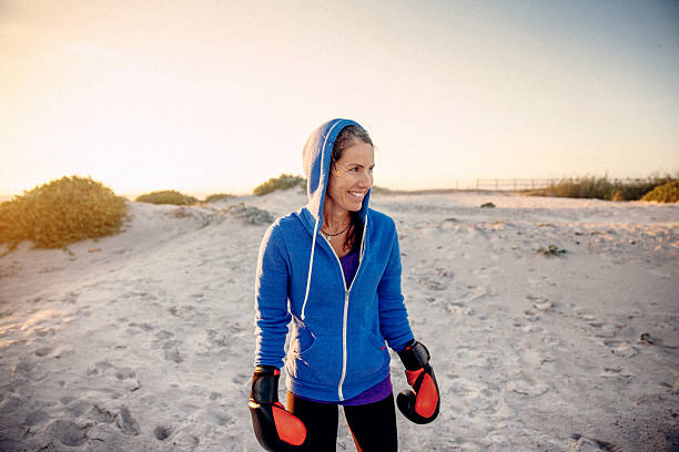 istock Woman training boxing on the beach 471931722