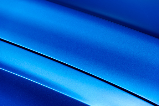 Surface of blue sport sedan car metal hood; part of vehicle bodywork