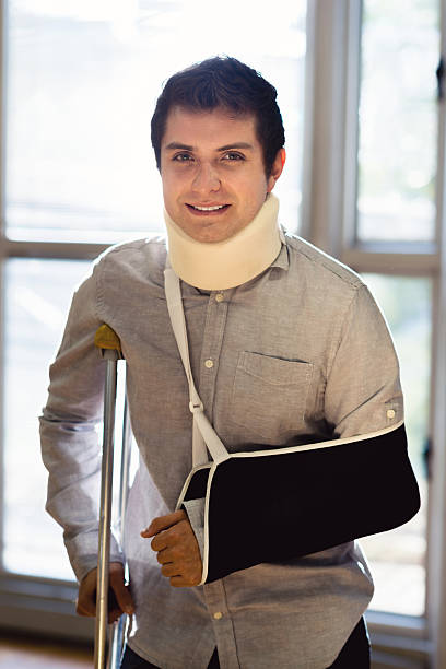 Injured man after being on an accident Injured man at the hospital after being on an accident man with arm sling stock pictures, royalty-free photos & images