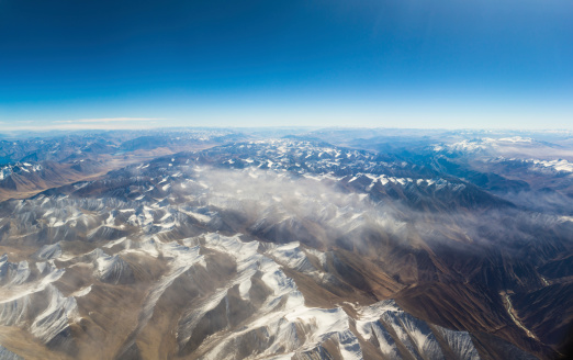 aerial view of mountains and clouds on top
