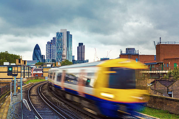 London Overground with skyscrapers in the background stock photo