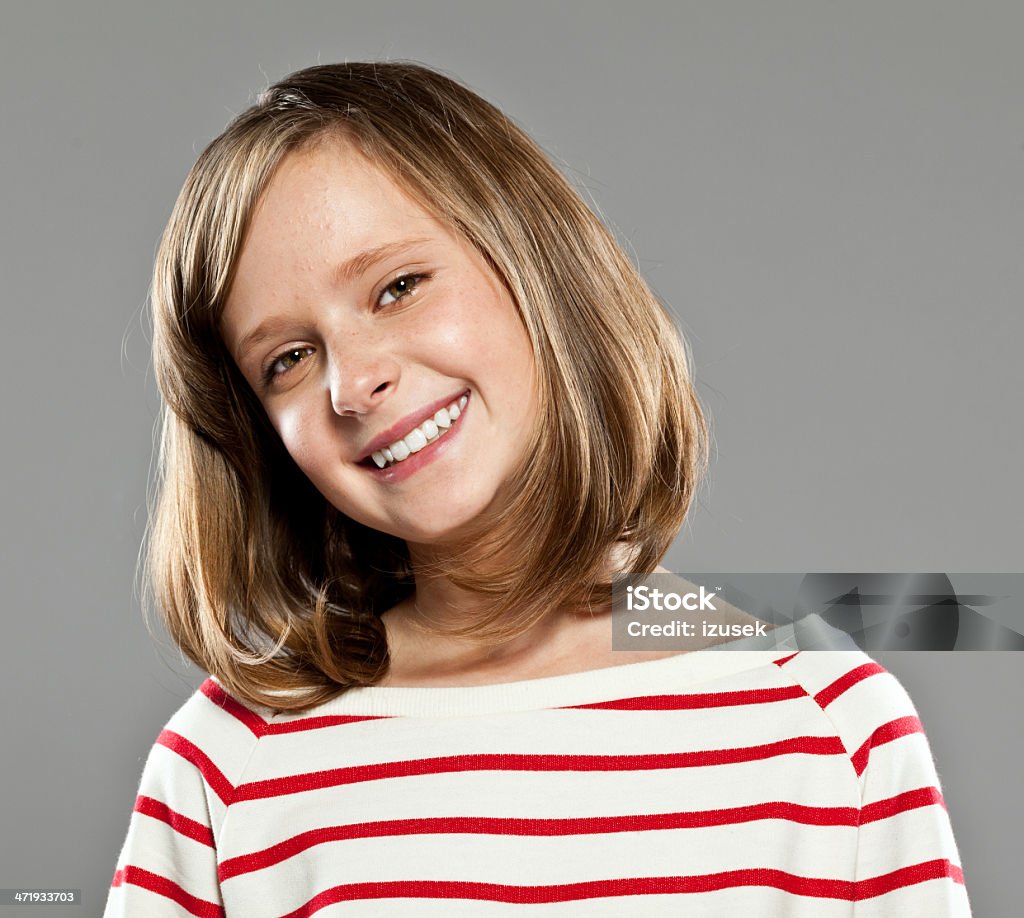 Happy cute girl Portrait of beautiful girl wearing striped blouse smiling at camera, Studio shot. 10-11 Years Stock Photo