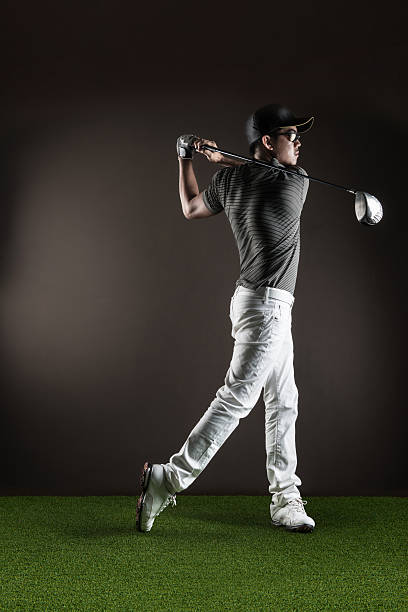 istock Male golfer portrait mid swing 471934519