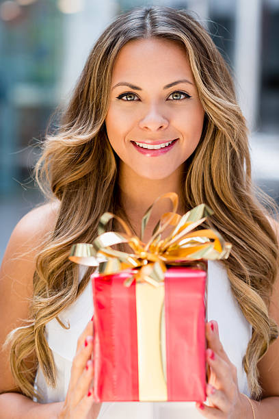 istock Woman holding a Christmas gift 471934831