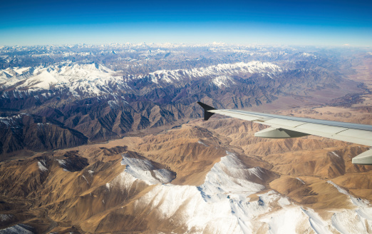 aerial view of mountains and clouds on top