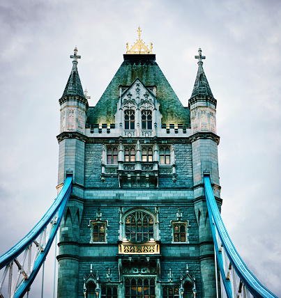 One of the two towers of the famous Tower Bridge in London. Photographed at dusk.